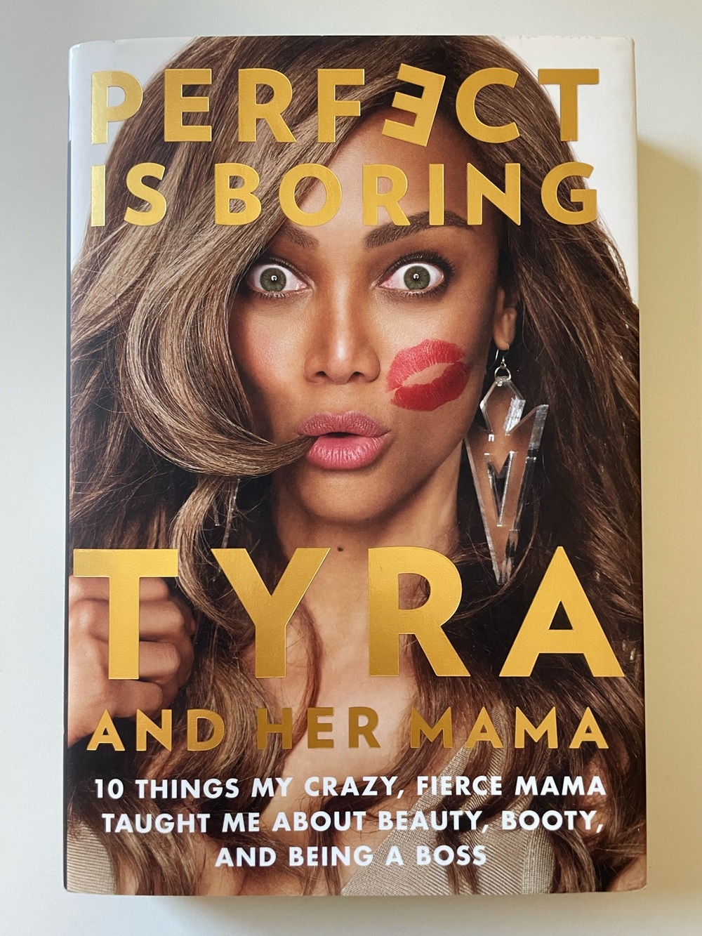 Tyra And Her Mama “Perfect Is Boring” Hardcover with Gold Lettering. 313 Pages.